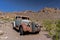 In Nevada, an old vintage car sits in the desert landscape.