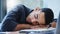 Never push yourself to a burnout. a young businessman feeling exhausted and sleeping on his desk in his office.