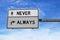 Never and always road sign on blue sky background.. White two street signs with arrow on metal pole. Directional road, Crossroads