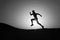 Never stop. Silhouette man motion running in front of sunset sky background. Future success depends on your efforts now