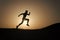 Never stop. Silhouette man motion running in front of sunset sky background. Future success depends on your efforts now