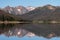 The Never Summer Mountain Range is reflected in Long Draw Reservoir, Colorado.