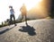 Never on time, but always on pace. Low angle shot of two people running on a tarmac road.