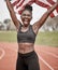 Never underestimate my abilities. a young female athlete celebrating her win while running with a flag.