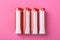 New AA batteries on pink background, flat lay