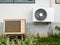 New air conditioner condenser and old air conditioner condenser unit standing outdoors