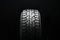 new all terrain tire. All-road universal tire tread with ground hooks on a black background