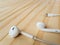 New Apple Lightning EarPods on wooden table