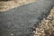 New asphalt. Construction of path in park. Details of road surface