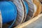 New blue power cable is wound on wooden coil. Background. Cable for laying underground.