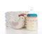 New born child composition stack of diapers toy and baby feeding