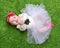 New born Infant child baby girl lying happy smiling on green grass blanket