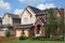 New brick cottage with garage at sunny day.