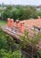 New brick house with red roof tile pattern and modular chimney, plastic windows and rain gutter.