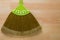 New broom made of synthetic Nylon fiber with green handle on woo