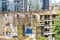 New building under construction and construction site of a residential building. Workers of different specialties work at the site