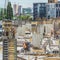 New building under construction and construction site of a residential building. Workers of different specialties work at the site