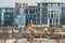 New building under construction and construction site of a residential building. Workers of different specialties work at the site