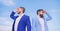 New business directions. Developing business direction. Businessmen bearded faces stand back to back sky background. Men