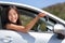 New car driver woman holding keys for travel road trip. Happy young Asian girl with rental lease or purchase of