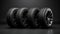 New car tires. Group of road wheels on dark background. Summer Tires with asymmetric tread design. Driving car concept.