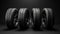 New car tires. Group of road wheels on dark background. Summer Tires with asymmetric tread design. Driving car concept.