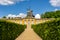 New Chambers (Neue Kammern) palace and Windmill (Windmuhle) in Sanssouci park in spring, Potsdam, Germany