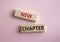 New Chapter symbol. Concept word New Chapter on wooden blocks. Beautiful pink background. Business and New Chapter concept. Copy
