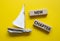 New Chapter symbol. Concept word New Chapter on wooden blocks. Beautiful yellow background with boat. Business and New Chapter