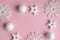 New Christmas pink and white decorations on a pastel pink background with space for text. Layout of a postcar