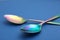 New clean colorful tablespoons on blue