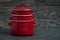 New And Clean Covered Red Saucepans on Blue Wooden Background