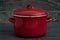 New And Clean Covered Red Saucepans on Blue Wooden Background