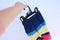 New colorful beach shorts, underpants on hanger in female hand, close up. beach wear for men, mens wear, checks their quality,