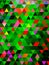 New colourful pattern of triangles designed digitally on green surface.