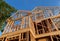 New construction home framing against a blue sky