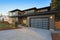 New construction home with low slope roof and brown siding.