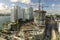 New construction site of developing residence in American urban area. Industrial tower lifting cranes in Miami, Florida