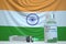 New coronavirus vaccine with flag of India as a background. Indian medical research and vaccination, 3D rendering