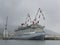 New Cruise ship moored in a shipyard with large cranes