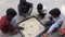 New Delhi India â€“ March 5 2021 : Street children playing carom board in the street, carrom board, Indian traditional indoor