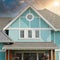 New Designer Home House Blue Exterior Roof Peak Details Cloudy Sunset Sky Background