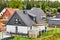 New detached house with white paint and dark roof with tiny garden with lawn in a narrow new housing estate