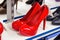 New elegant red women shoes on the retail clothing shop display shelf.