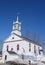 New England church with steeple, in winter