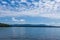 New England lake on bright cloudy blue day