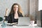 New entrepreneur showing confidence. confident and happy business woman sitting and smiling in the home office