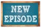 NEW EPISODE words on blue wooden frame school blackboard