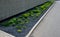 New established street in the city, the longitudinal parking lot is made of gray concrete infiltrating tiles with crevices filled