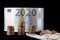 New fiscal year 2020 represented with euro bills and coin stacks isolated on black. Conceptual image regarding the economical